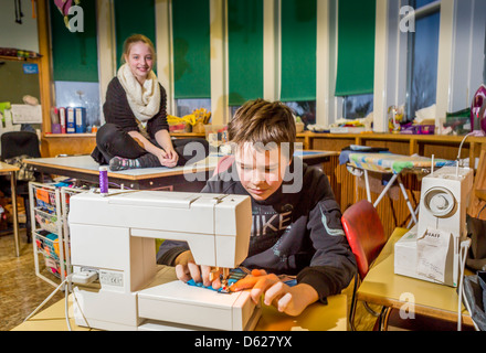 Young boy learning to sew at school, Reykjavik, Iceland Stock Photo
