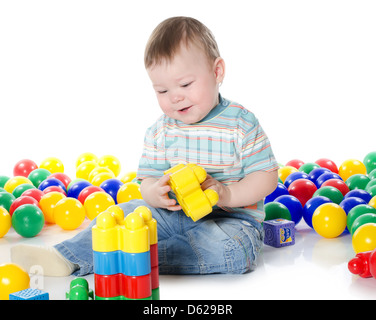 The little boy plays multi-coloured toys Stock Photo