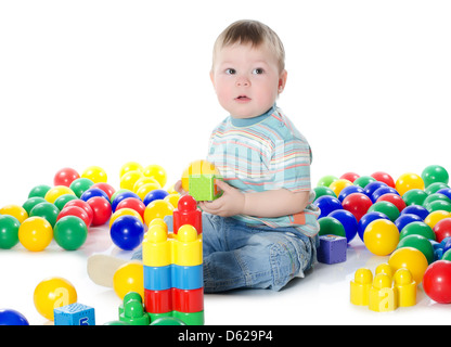 The little boy plays multi-coloured toys Stock Photo