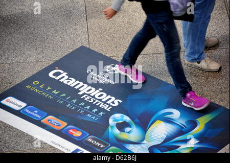 A woman walks past an advertisement for the Champions Festival in Munich, Germany, 18 May 2012. Thousands of fans will make their way to the Bavarian city for the Champions League final match between FC Bayern Munich and FC Chelsea on 19 May 2012. Photo: NICOLAS ARMER Stock Photo