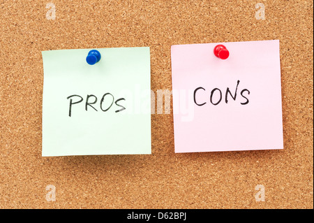 Pros and cons written on paper and pinned on cork board Stock Photo