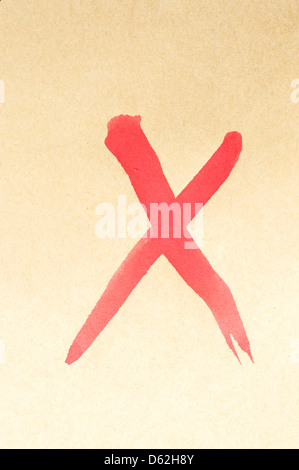 Cross mark symbol written on brown paper Stock Photo