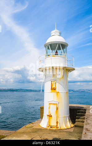 The lighthouse at the end of the breakwater beside Brixham Marina overlooking Torbay, Devon, England. Stock Photo