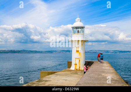 The lighthouse at the end of the breakwater beside Brixham Marina overlooking Torbay, Devon, England. Stock Photo