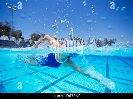 Female swimmer in United States swimsuit swimming in pool Stock Photo