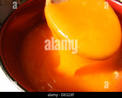 A photo depicting the process of beating eggs and yolks, commonly used in cooking. The image shows the mixture in a bowl, emphasizing the texture and color of the beaten eggs. Stock Photo