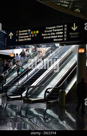 Travelers on an escalator in Chicago's O'Hare International Airport, Illinois. Stock Photo