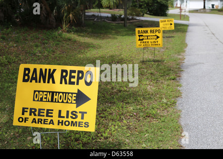 Signs along a street in the USA that say Bank Repo open house pointing to a home for sale Stock Photo