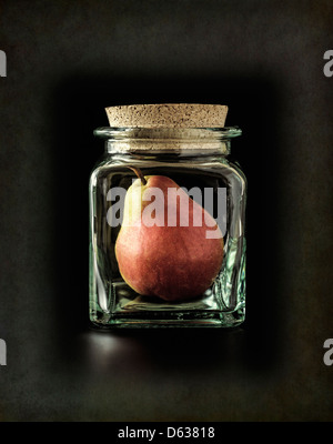 Pear trapped in glass jar