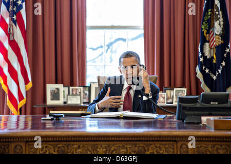 Wahington DC, USA. 11th April 2013. US President Barack Obama talks on the phone with Nicole Hockley and families of the victims of the Sandy Hook Elementary School shootings in Newtown from the Oval Office April 11, 2013 in Washington, DC. Obama was looking to the families to pressure Congress to act on gun legislation. Credit: White House Photo / Alamy Live News Stock Photo