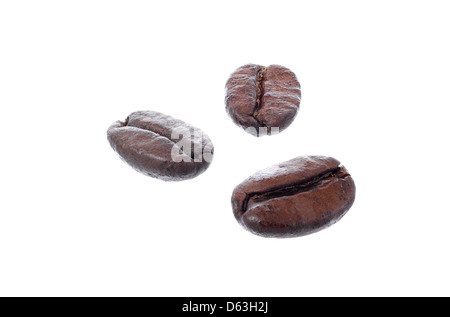 Roasted arabica coffee beans isolated on white background. DOF increased by fucus stack. Placed beans resemble human face. Stock Photo