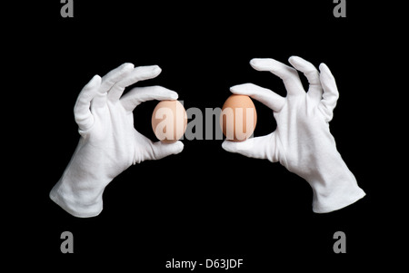 eggs in white gloves on wizards hands magic Stock Photo