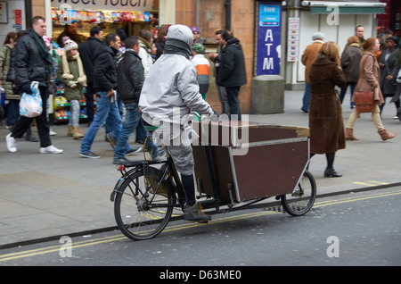 Man pedaling on Oxford Street in London. Stock Photo