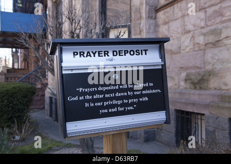 Sign in front of church encourages parishioners to deposit written prayers that will be offered to God by it's ministers. Stock Photo