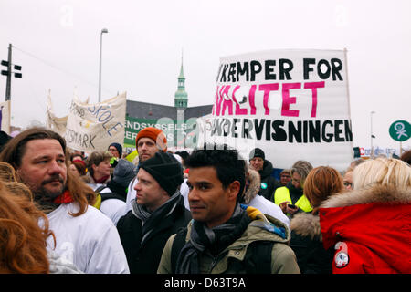 Copenhagen, Denmark. 11th April 2013. 40,000 teachers from all over Denmark demonstrate in front of the parliament building, Christiansborg Palace, against the ongoing lockout of teachers and the government's reform plans to cut teacher preparation time to finance longer school days. Banner text: 'We fight for quality in teaching'. Credit:  Niels Quist / Alamy Live News Stock Photo