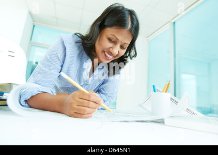 Portrait of mature businesswoman working with papers in office Stock Photo