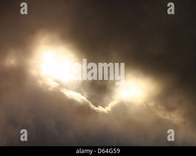 An image showcasing unusual and ominous clouds in the sky, resembling an evil beast. The dark clouds create a dramatic and eerie atmosphere, capturing the power of nature's formations in the sky. Stock Photo