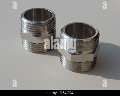 Brass chrome-plated nipples are commonly used in plumbing and piping systems. These fittings are designed for connecting pipes or tubes and are known for their durability and corrosion resistance. Stock Photo