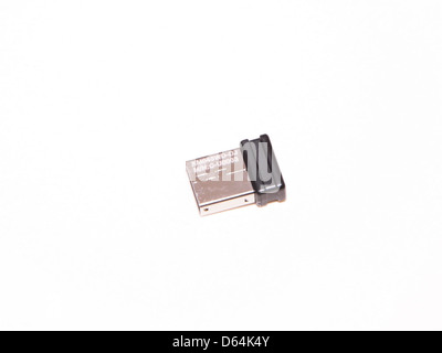 The image features a Logitech wireless micro receiver, a device used to connect wireless peripherals such as keyboards and mice to computers. The compact size of the receiver makes it ideal for portable devices and helps reduce cable clutter in workspaces. Stock Photo