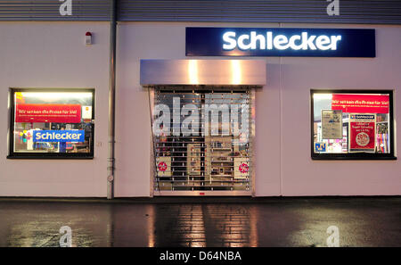 A storefront with the logo of the German drugstore Schlecker is pushed through a shop in Goeggingen, Germany, 31 May 2012. The future of the bankrupt drugstore chain will be decided on this friday 1 June in Berlin. Schlecker's three biggest creditors will meet at an unknown location an decide whether the chain will be closed completely or whether it will be safed. Photo: Jan-Philip Stock Photo