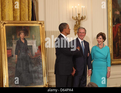 United States President Barack Obama (left), former U.S. President George W. Bush (center), and former first lady Laura Bush (right) joke around at the unveiling of the official White House Bush portraits at the White House in Washington, DC, Thursday, May 31, 2012. .Credit: Chris Kleponis / CNP Stock Photo