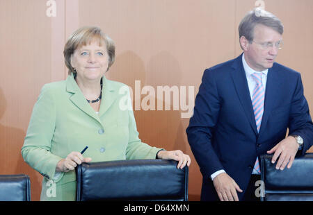German Chancellor Angela Merkel (CDU) and German Minister for Special Affairs Ronald Pofalla (CDU) arrive for the cabinet meeting at the Federal Chanceelery in Berlin, Germany, 06 June 2012. The cabinet has agreed on the controversial Betreuungsgeld (childcare money). Parents who take care of their small children themselves and do not make use of a state creche or day mother will i Stock Photo
