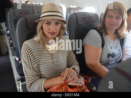 Lena Gercke (l), the first winner of Germany's Next Top Model and girlfriend of Germany's Sami Khedira, sits in a plane before departure in Gdansk, Poland, 09 June 2012, ahead of of the Group B preliminary round match of the UEFA EURO 2012 between Germany and Portugal in Lviv, Ukraine on 09 June 2012. Photo: Marcus Brandt dpa Stock Photo