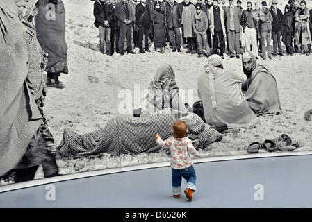 A young visitors walks towards a tapestry by Polish artist Goshka Macuga at Museum Fridericianum during the art exhibition documenta (13) in Kassel, Germany, 09 June 2012. Documenta (13) was officially opened today and will end on 16 September 2012. Photo: Uwe Zucchi Stock Photo