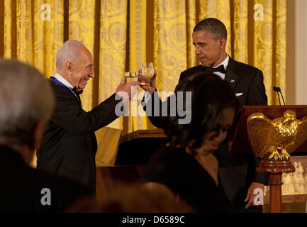 United States President Barack Obama offers a toast to President Shimon Peres of Israel following his being awarded the Presidential Medal of Freedom during a dinner in his honor in the East Room of the White House in Washington, D.C. on Wednesday, June 13, 2012..Credit: Martin Simon / Pool via CNP Stock Photo
