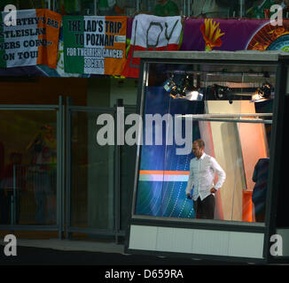 Former German national football player Mehmet Scholl, now working as a TV-expert for German broadcaster ZDF, stands at the window of a TV-Studio prior to UEFA EURO 2012 group C soccer match Spain vs Italy at Arena Gdansk in Gdansk, Poland, 14 June 2012. Photo: Marcus Brandt dpa (Please refer to chapters 7 and 8 of http://dpaq.de/Ziovh for UEFA Euro 2012 Terms & Conditions) Stock Photo