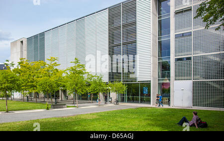 A student sits in front of the auditorium center at the Technical University (TU) in Dresden, Germany, 15 June 2012. The TU received the distinction as an elite university on Friday. It is the first university in the new states of Germany to receive this distinction and is connected subsidies worth millions. Photo: OLIVER KILLIG Stock Photo