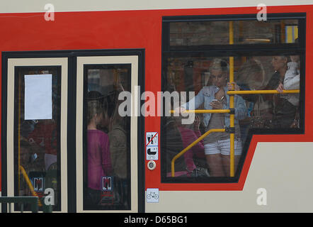 A young woman stands in a tram in Gdansk, Poland, 15 June 2012. The EURO 2012 runs from 08 June till 01 July and takes place in Poland and the Ukraine.  Photo: Marcus Brandt dpa Stock Photo