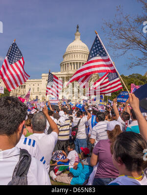 Washington DC, USA. 10th April 2013. People wave American flags during immigration reform rally at U.S. Capitol. Credit: Rob Crandall / Alamy Live News Stock Photo