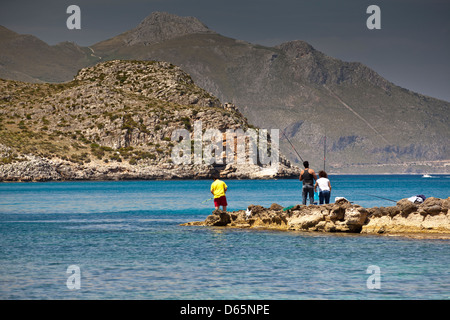 People fishing in the coastal inlet of Calabianca in the province of Trapani in Sicily. Stock Photo