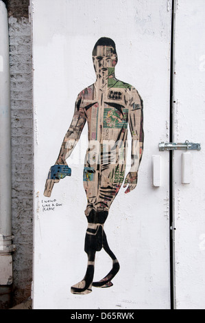 Graffiti art in Shoreditch , London , referencing Oscar Pistoius, showing a man with blades holding a gun Stock Photo