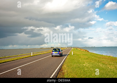 Driving on the dyke to Marken in the Netherlands Stock Photo