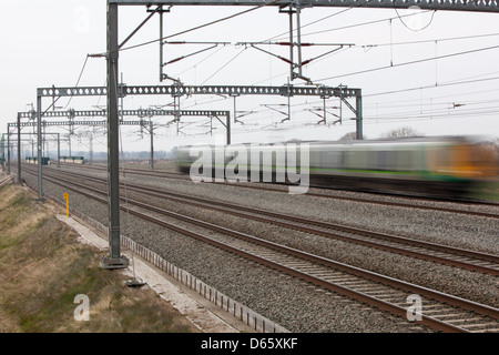 A London Midland train speeds along the West Coast Main Line railway. Stock Photo
