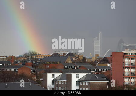 London, UK. Friday 12th April 2013. A rainbow appears during a heavy April shower near the City. Credit: Monica Wells/Alamy Live News Stock Photo