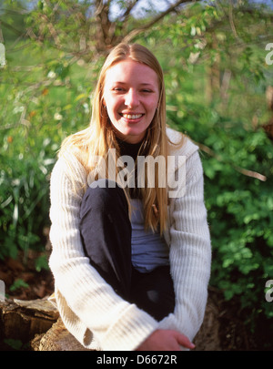 Young woman smiling (20's) outdoors, Sunningdale, Berkshire, England, United Kingdom Stock Photo