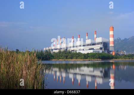 coal power plants encircled by forest and mountain Stock Photo