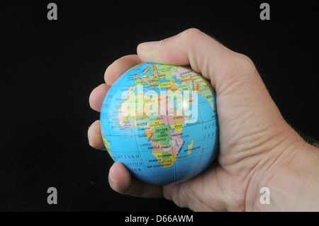 Globe in an hand on a black background Stock Photo