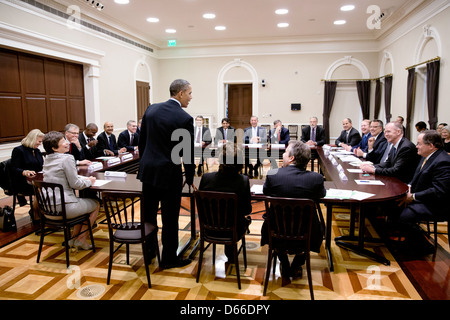 US President Barack Obama drops by a meeting with the Business Roundtable CEO Committee in the Eisenhower Executive Office Building of the White House March 13, 2013 in Washington, DC. Stock Photo