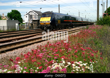 GNER, 82 class DVT Electric train, East Coast Main Line, Helpston crossing, Peterborough, Cambridgeshire, England Stock Photo