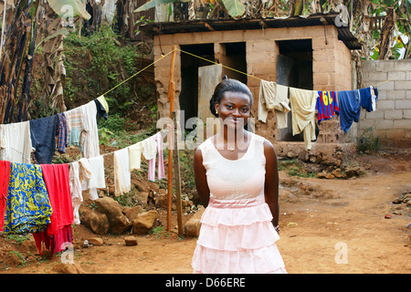Beautiful young African woman in backyard with clothesline Stock Photo