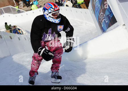A competitor in the Red Bull Crashed Ice competition skates down the track during competition at the St. Paul Winter Carnival. Stock Photo