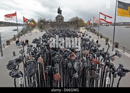 An 18 times five metre large field of sunflowers made of aluminium by Chinese artist Xu Jiang is featured in front of an equestrian statue of German Emporer Wilhelm as part of the exhibition 'Xu Jiang and Shi Hui. Flourishing Spirits' of the Ludwig Museum in Koblenz, Germany, 12 April 2013. Photo: Thomas Frey Stock Photo