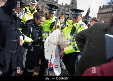 George Square, Glasgow, Scotland, UK. Saturday 13th April 2013. Police remove an effigy of recently deceased Baroness Margaret Thatcher during a 'Thatcher is Dead' party, after an attempt by young protestors to burn the effigy, in George Square. Credit: Jeremy Sutton-hibbert /Alamy Live News Stock Photo