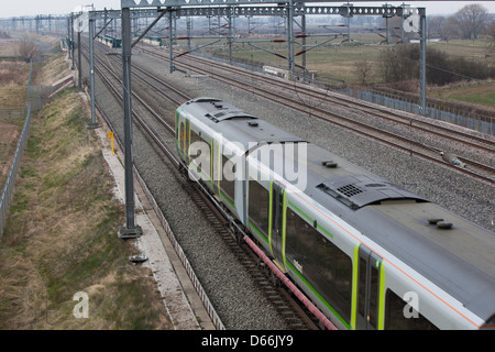 A London Midland train on the West Coast Mainline in the Midlands. Viewed from above. Stock Photo