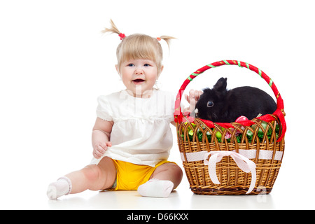 funny baby girl with Easter bunny in basket Stock Photo