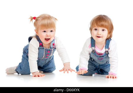 Funny kids girls crawling on floor Stock Photo